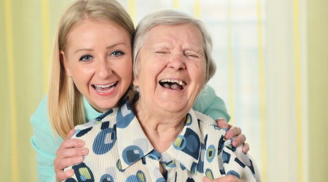 caregiver and senior laughing